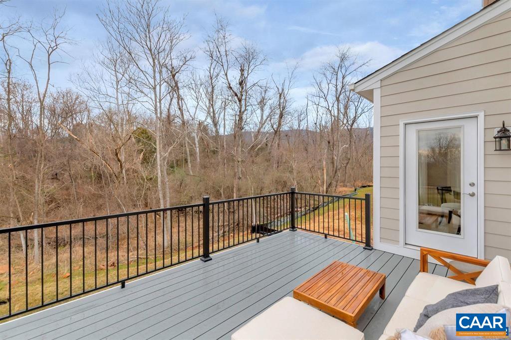 2837 Rambling Brook Lane Crozet, VA 22932 - Photo 13 of 24 a view of a roof deck with wooden floor and fence