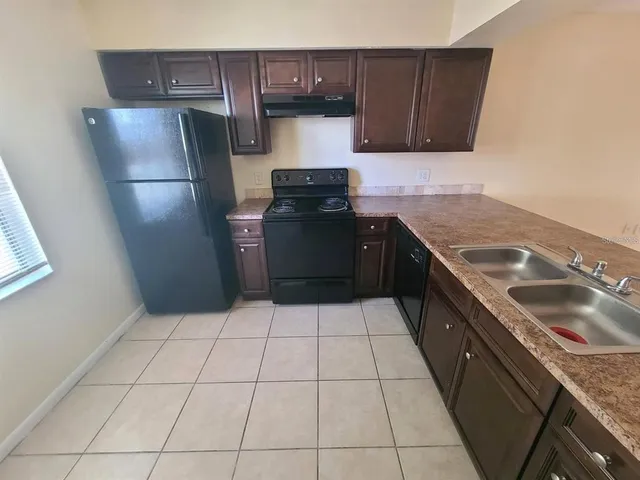 a kitchen with a sink a stove and refrigerator