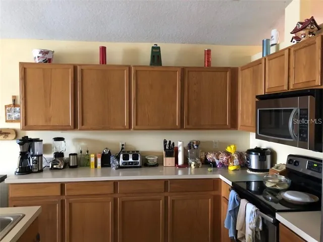 a kitchen with cabinets a sink and a stove