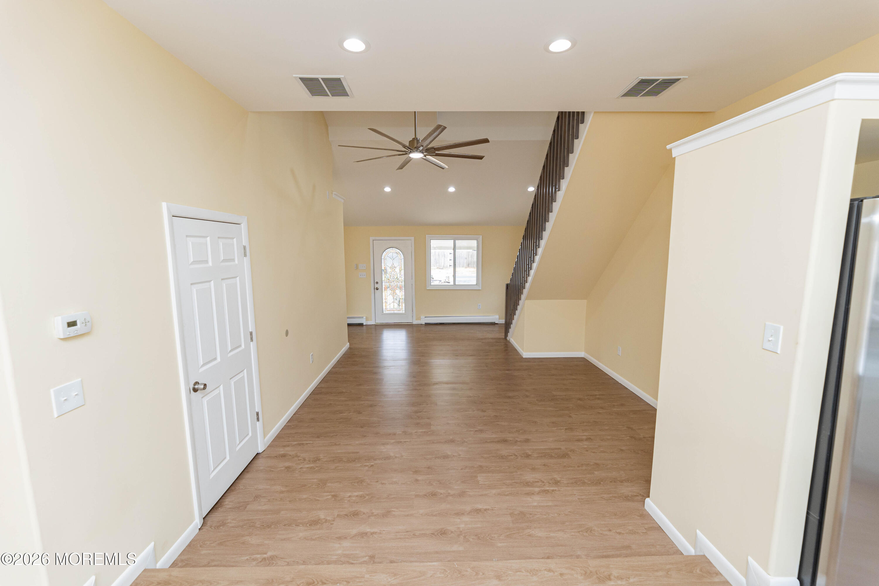2408 Herbertsville Road Point Pleasant, NJ 08742 - Photo 26 of 82 a view of a hallway with wooden floor and staircase