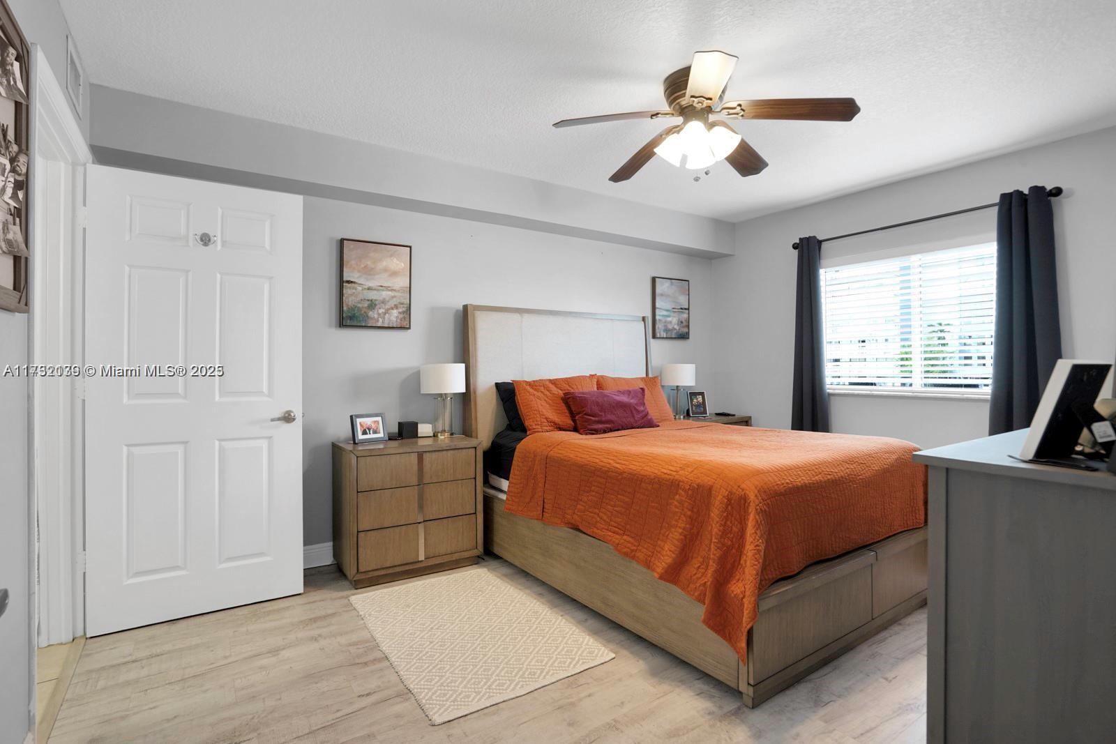 2475 Northwest 16th St Road, Unit 216 Miami, FL 33125 - Photo 13 of 16 a bedroom with a bed and a large window