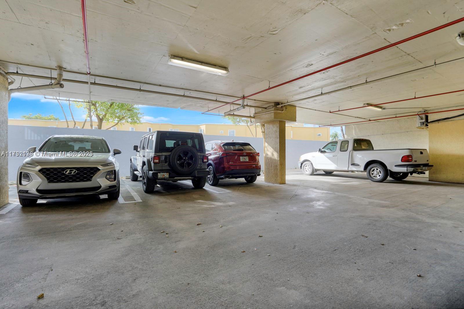 2475 Northwest 16th St Road, Unit 216 Miami, FL 33125 - Photo 16 of 16 a view of cars parked in a parking