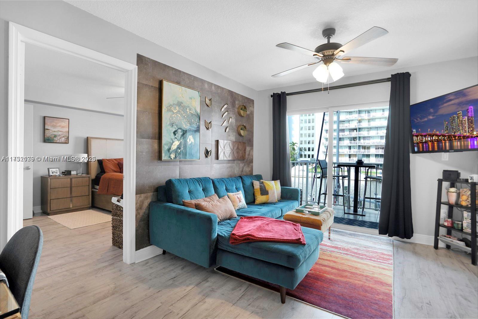 2475 Northwest 16th St Road, Unit 216 Miami, FL 33125 - Photo 3 of 16 a living room with furniture and a flat screen tv