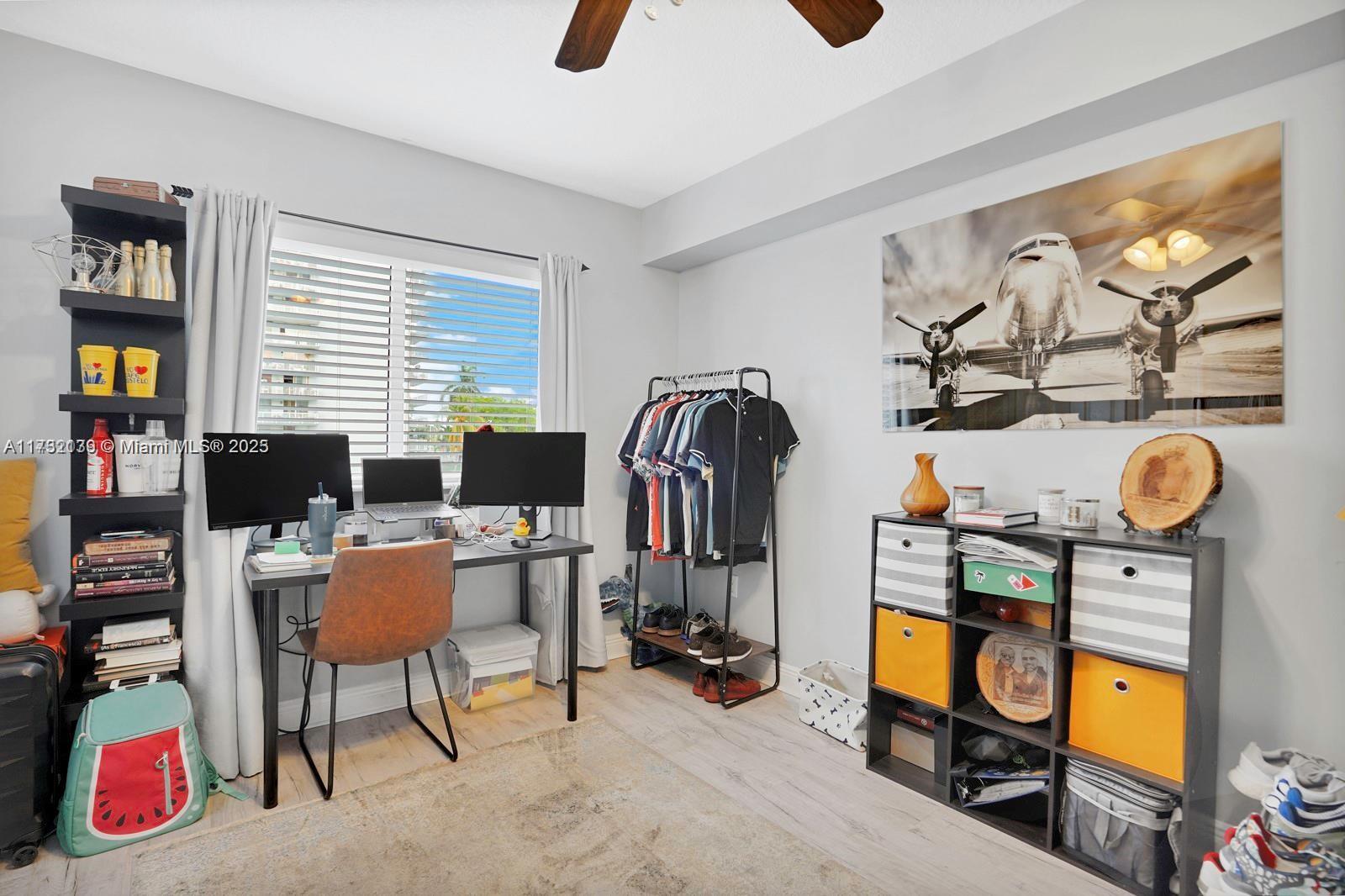 2475 Northwest 16th St Road, Unit 216 Miami, FL 33125 - Photo 5 of 16 a bedroom with furniture and a window