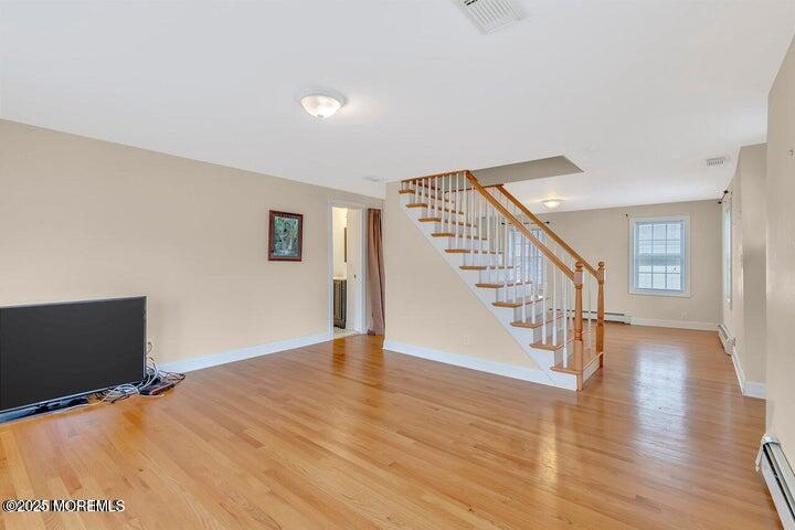 164 Jackson Street Matawan, NJ 07747 - Photo 13 of 27 a view of an empty room with wooden floor and stairs