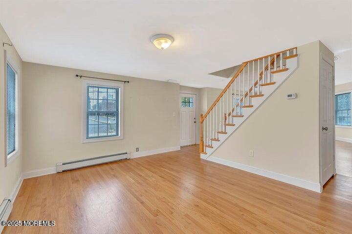 164 Jackson Street Matawan, NJ 07747 - Photo 16 of 27 a view of an empty room with wooden floor and stairs