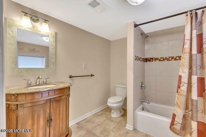 164 Jackson Street Matawan, NJ 07747 - Photo 10 of 27 a bathroom with a bathtub shower sink vanity and toilet
