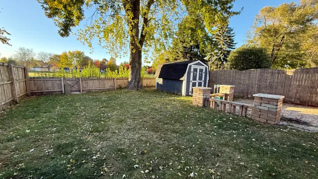 a view of a backyard with a garden and trees