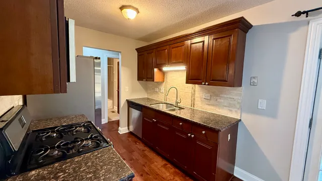 a kitchen with a stove and a refrigerator