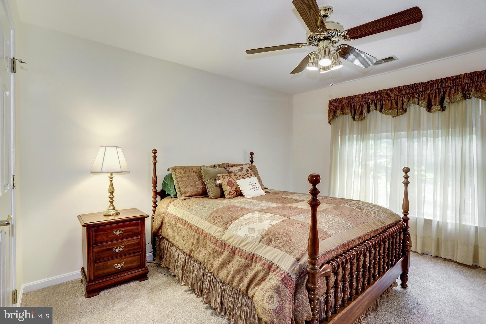 150 South River Landing Road, Unit 150 Edgewater, MD 21037 - Photo 14 of 28 a bedroom with a bed and a chandelier