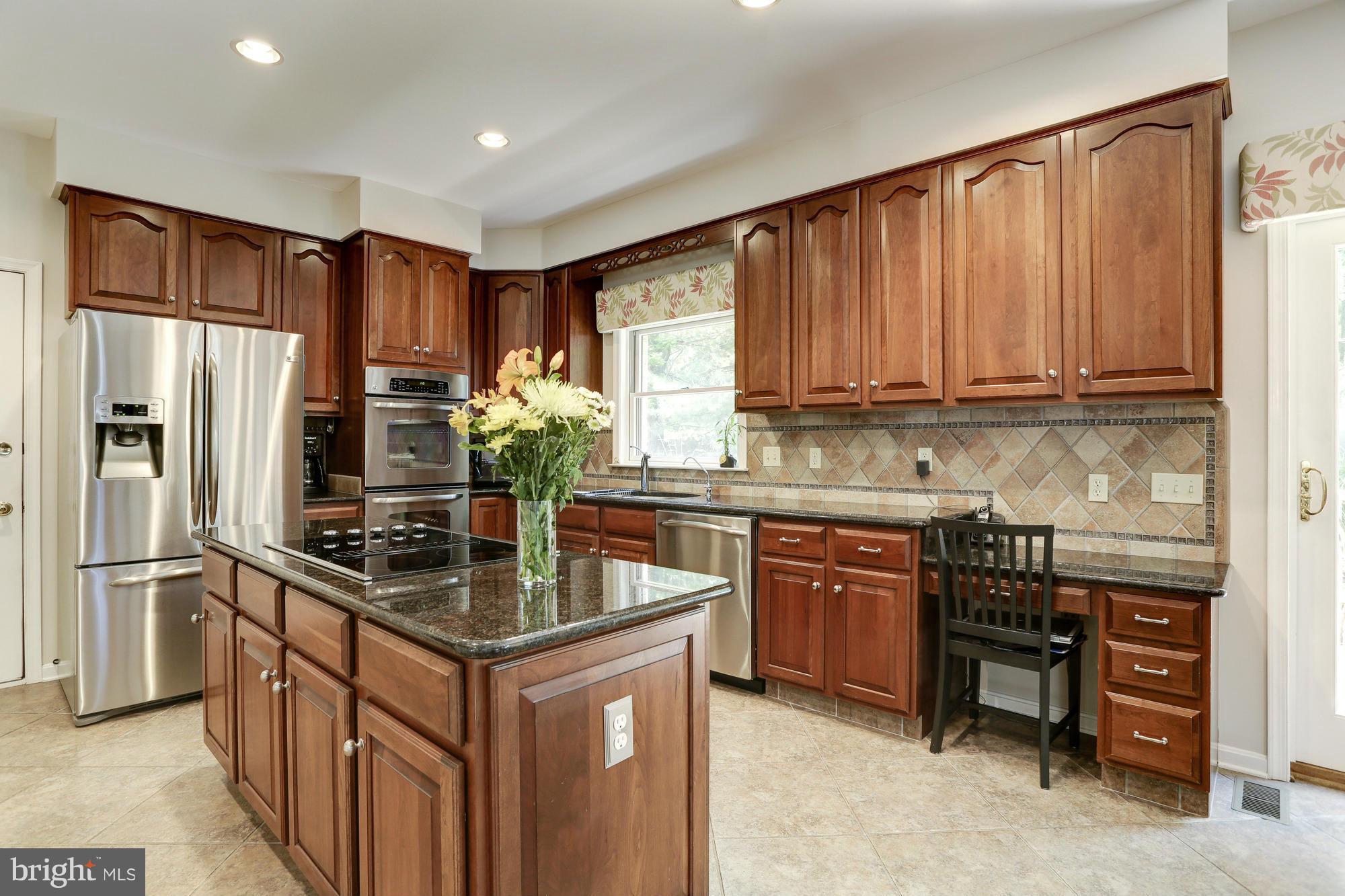 150 South River Landing Road, Unit 150 Edgewater, MD 21037 - Photo 8 of 28 a kitchen with stainless steel appliances granite countertop a stove refrigerator and microwave
