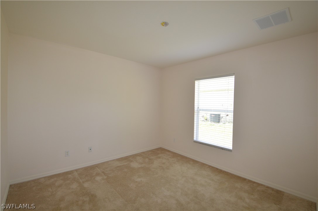 142 Ridgemont Drive Lehigh Acres, FL 33972 - Photo 11 of 15 an empty room with a window