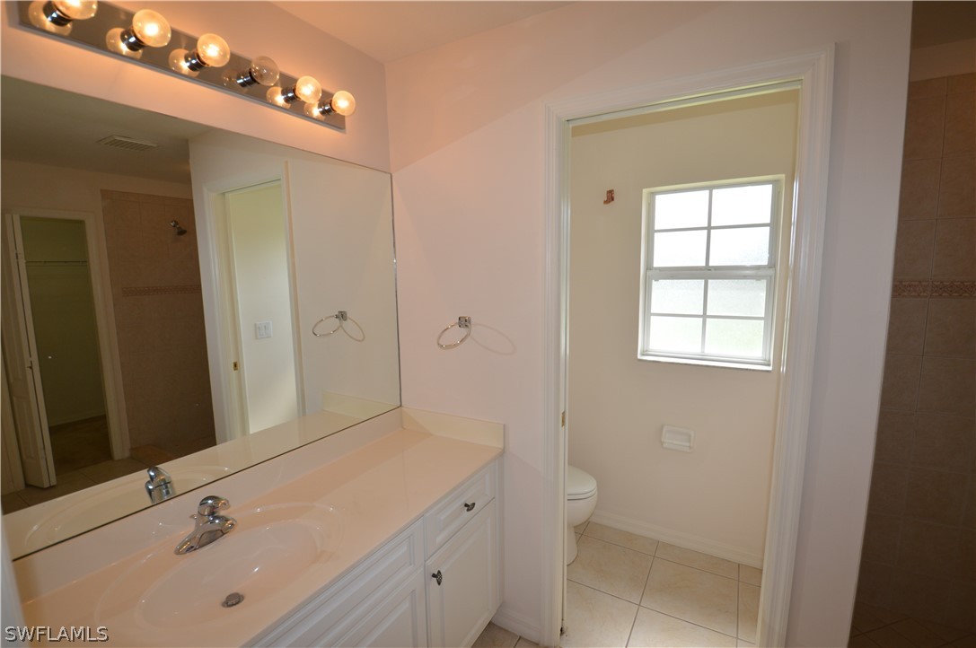 142 Ridgemont Drive Lehigh Acres, FL 33972 - Photo 12 of 15 a bathroom with a sink a toilet and shower