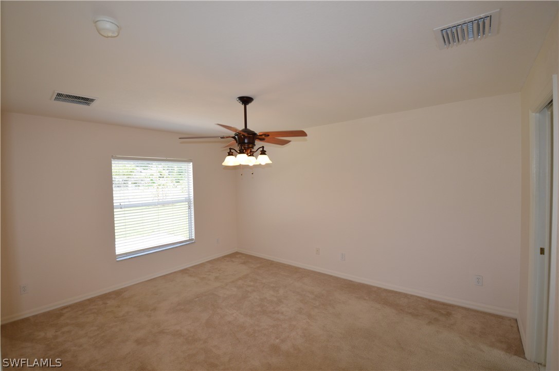 142 Ridgemont Drive Lehigh Acres, FL 33972 - Photo 13 of 15 a view of an empty room with a window