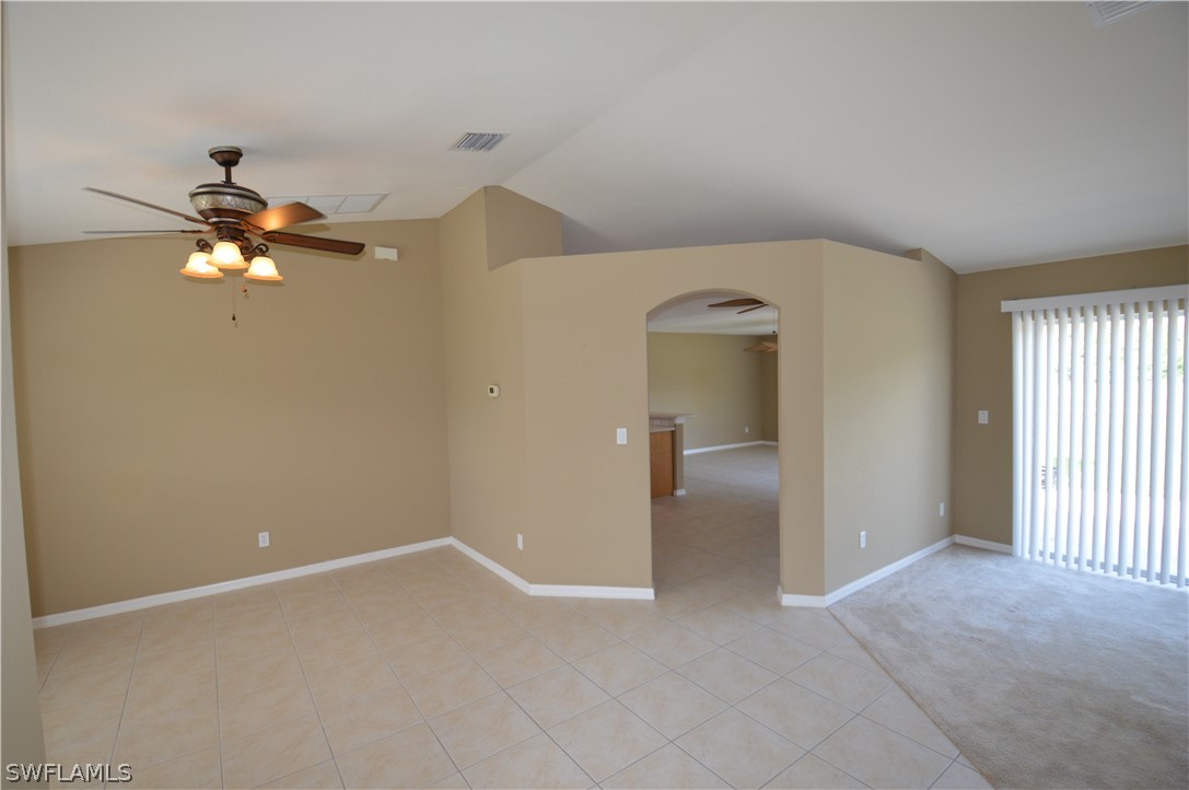 142 Ridgemont Drive Lehigh Acres, FL 33972 - Photo 3 of 15 an empty room with chandelier fan