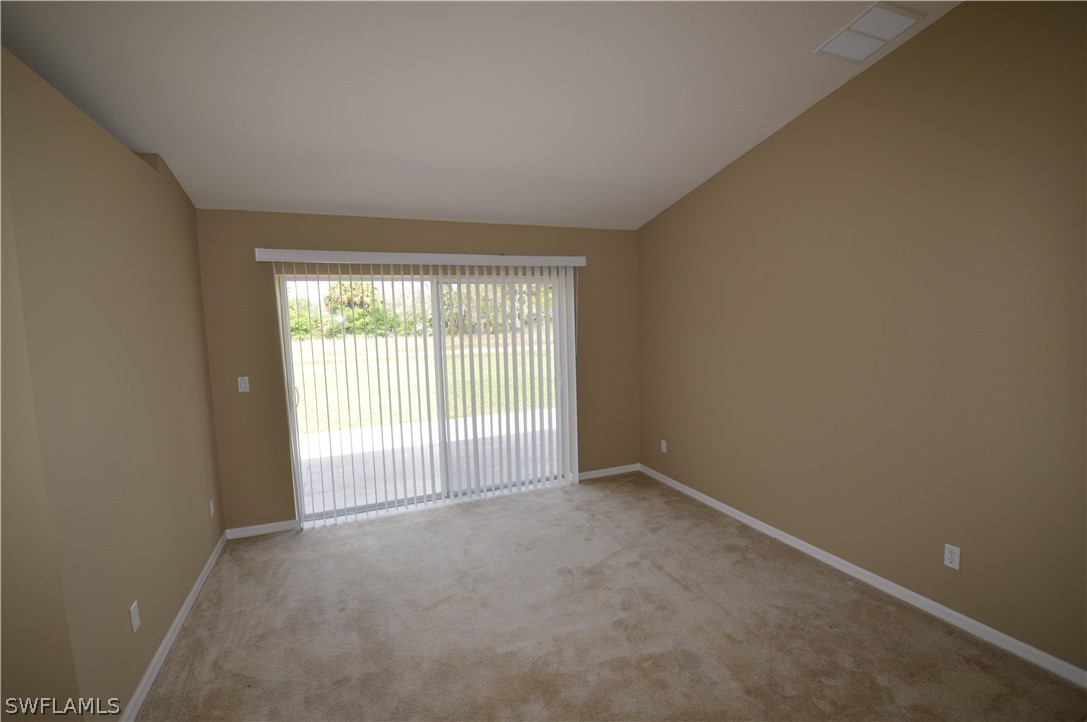 142 Ridgemont Drive Lehigh Acres, FL 33972 - Photo 4 of 15 an empty room with windows