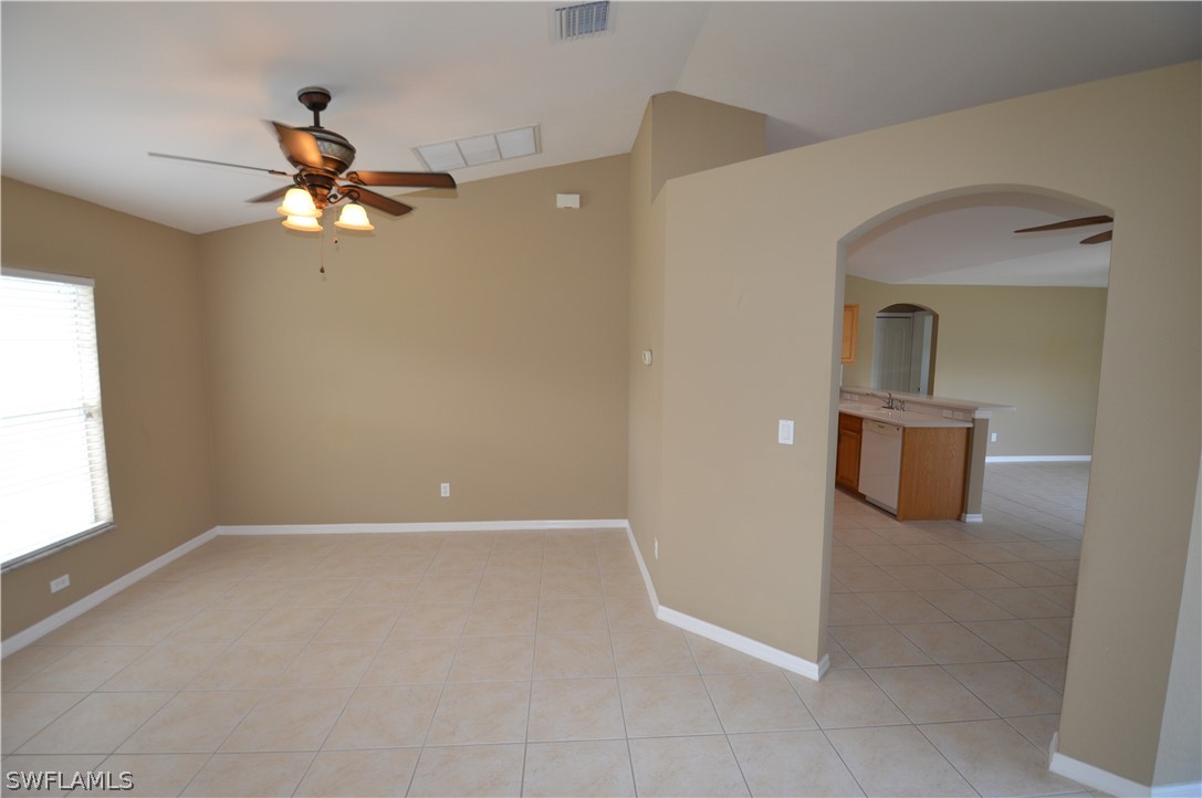 142 Ridgemont Drive Lehigh Acres, FL 33972 - Photo 5 of 15 wooden floor in an empty room with a window