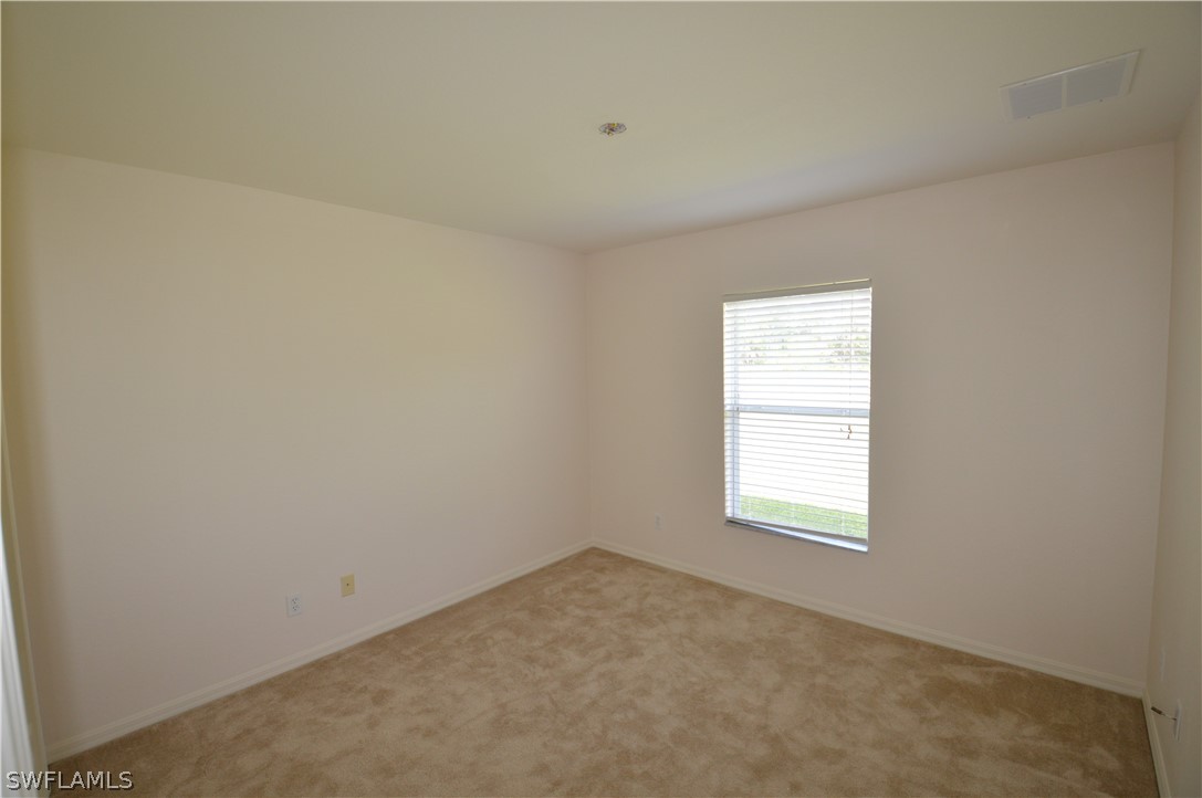 142 Ridgemont Drive Lehigh Acres, FL 33972 - Photo 9 of 15 an empty room with a window