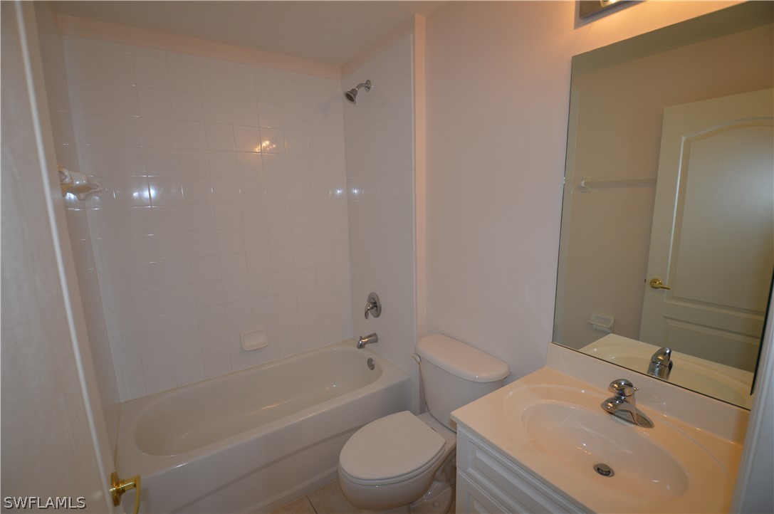 142 Ridgemont Drive Lehigh Acres, FL 33972 - Photo 10 of 15 a bathroom with a sink toilet and shower