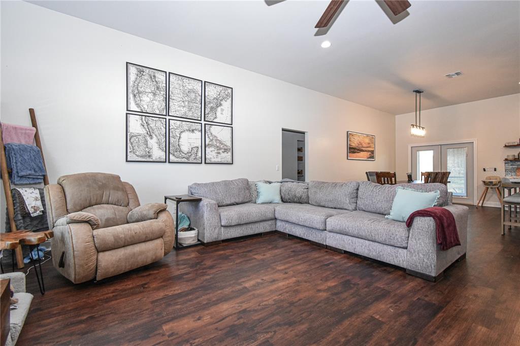 7890 Southwest 129th Avenue Cedar Key, FL 32625 - Photo 16 of 45 a living room with furniture and a wooden floor