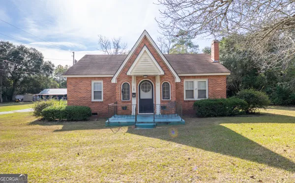 a view of a house with swimming pool and a yard