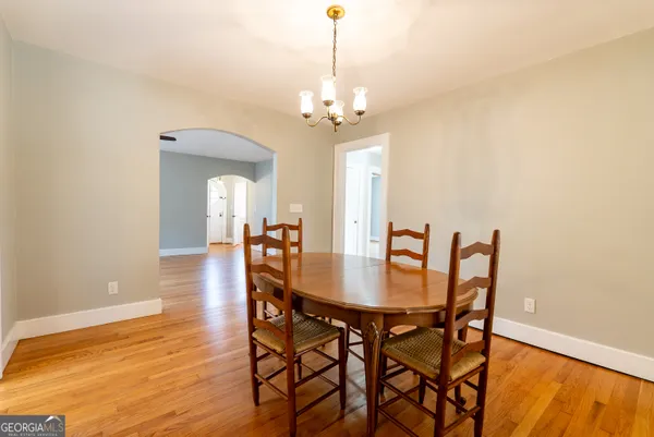 a view of a dining room with furniture and chandelier