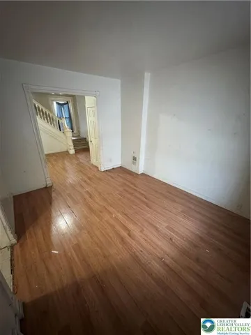 a view of an empty room and wooden floor