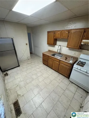 a kitchen with stainless steel appliances a sink and a stove