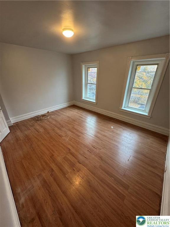 424 Liberty Street Allentown, PA 18102 - Photo 10 of 15 an empty room with wooden floor and windows