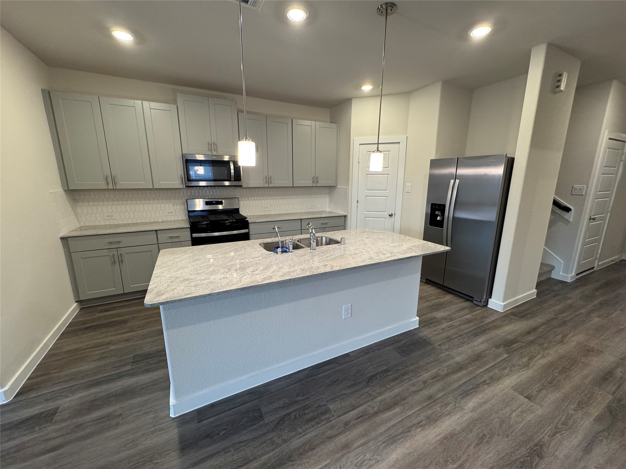 18731 Frost Ridge Drive Crosby, TX 77532 - Photo 8 of 26 a kitchen with stainless steel appliances a refrigerator a sink a stove a microwave and island