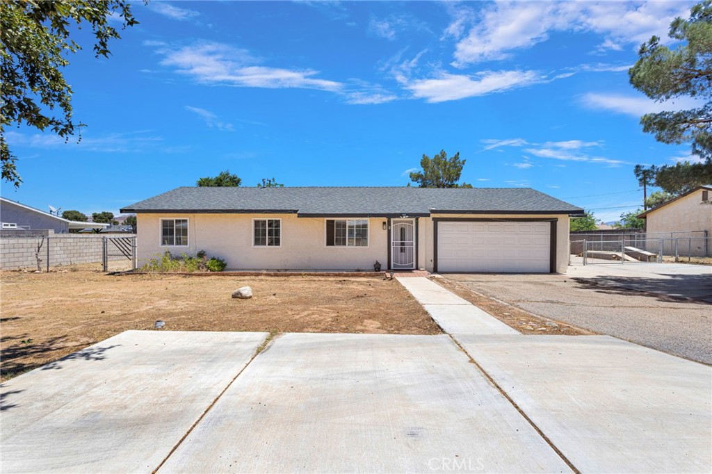 15471 Washoan Road Apple Valley, CA 92307 - Photo 3 of 38 a front view of a house with a yard