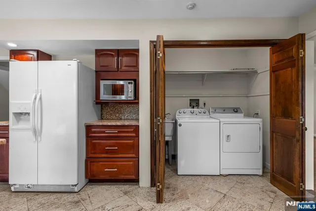 a utility room with cabinets washer and dryer