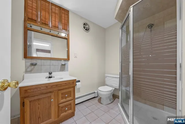 a bathroom with a sink toilet a mirror and shower