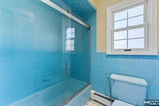 a bathroom with a shower and a toilet