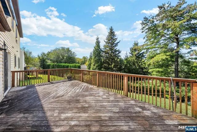 a view of balcony with wooden floor and fence