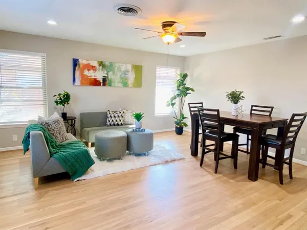 a living room with furniture potted plant and window
