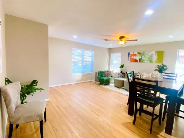a view of a dining room with furniture and a potted plant