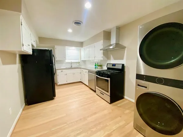 a kitchen with a stove and a refrigerator