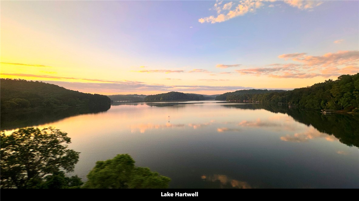 26 Wilbanks Road Seneca, SC 29678 - Photo 15 of 47 Golden hour reflections dance across the tranquil waters, embracing serene shores and distant hills.