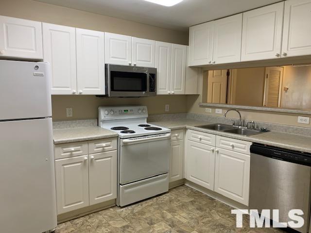 929 Morreene Road, Unit C21 Durham, NC 27705 - Photo 2 of 9 a kitchen with a sink stove and cabinets