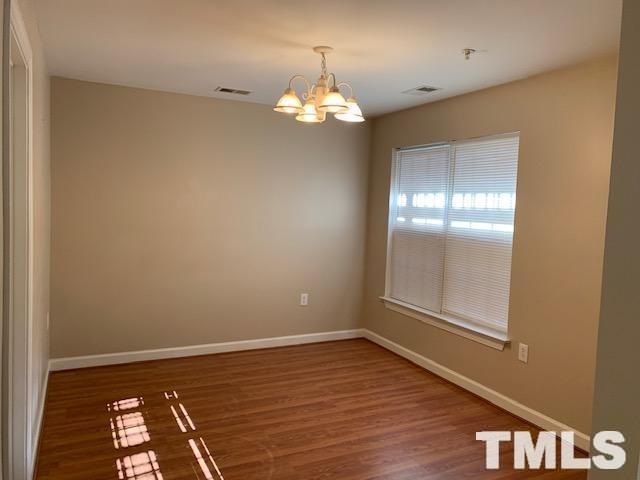 929 Morreene Road, Unit C21 Durham, NC 27705 - Photo 4 of 9 a view of an empty room with wooden floor and a window