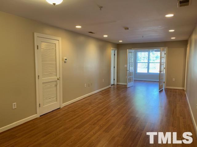 929 Morreene Road, Unit C21 Durham, NC 27705 - Photo 6 of 9 an empty room with wooden floor and windows