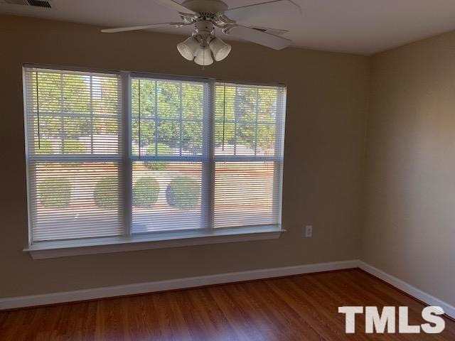 929 Morreene Road, Unit C21 Durham, NC 27705 - Photo 7 of 9 a view of an empty room with wooden floor and a window