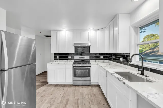 a kitchen with a sink stove and refrigerator