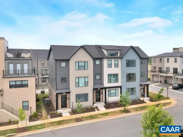a front view of a residential apartment building with a yard