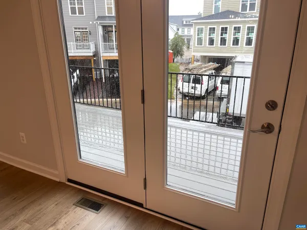 a view of balcony with wooden floor