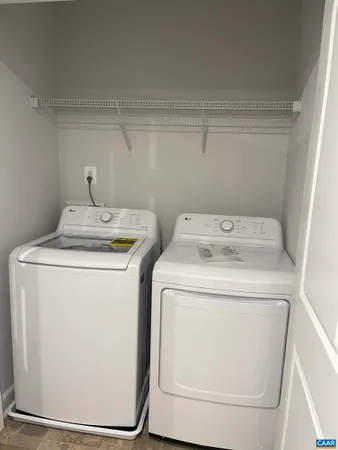 an empty room with windows and chandelier fan