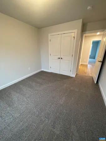 a bathroom with a granite countertop toilet sink and mirror