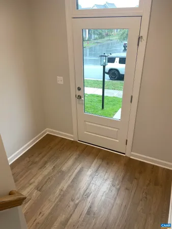 a view of wooden floor and windows in a room