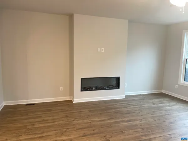a room with a window and wooden floor
